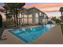 Backyard view showcasing a stunning pool with a hot tub at a gorgeous single Gathering home at 7904 Riviera Beach Dr, Las Vegas, NV 89128