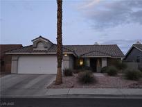 Charming single-story home with a well-manicured front yard and a two-car garage in a quiet neighborhood at 824 Holly Lake Way, Henderson, NV 89002