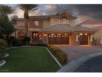 Stunning two-story home with a three-car garage, lush lawn, and stone accents at 9000 Thornbury Ln, Las Vegas, NV 89134