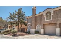 Inviting home exterior with a private garage and mature landscaping at 10115 Tree Bark St, Las Vegas, NV 89183