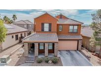 Beautiful two-story home with a tile roof, desert landscaping, and covered front porch at 1125 Via Canale Dr, Henderson, NV 89011