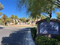 Welcoming entrance to Resort Villas, featuring lush landscaping, a decorative fountain, and a clear community sign at 2050 W Warm Springs Rd # 712, Henderson, NV 89014