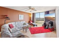 Cozy living room with large window and comfortable seating arrangement and city views at 3930 University Center Dr # 804, Las Vegas, NV 89119