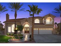 Inviting two-story home with arched entry, tile roof, and a well-manicured lawn at 4024 Mansion Hall Ct, Las Vegas, NV 89129