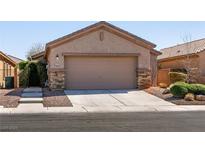 Charming one-story home showcasing a two-car garage and well-manicured front yard at 4125 Gliding Gulls Ave, North Las Vegas, NV 89084