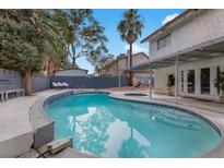 Backyard features a sparkling pool with a covered patio, offering an ideal outdoor living space at 4330 Flandes St, Las Vegas, NV 89121