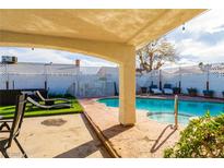 Relaxing backyard pool area with lounge chairs and covered patio for comfortable outdoor living at 4471 Wisconsin Ave, Las Vegas, NV 89104