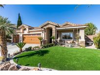 Charming single-story home with lush, landscaped front yard and welcoming stone accents at 489 Beaconwood St, Henderson, NV 89052