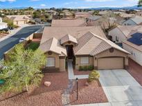 Charming single-story home with a well-maintained front yard and two-car garage in a Gathering-friendly neighborhood at 5601 Quail Meadow Ct, Las Vegas, NV 89131