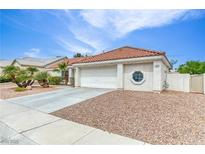 Charming single-story home with a tile roof, desert landscaping, and a two-car garage at 7820 Wedlock Ln, Las Vegas, NV 89129