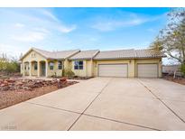 Charming single-story home with a three-car garage, tile roof, and desert landscaping at 822 Fairview Dr, Henderson, NV 89015