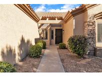 Inviting front entrance with desert landscaping and a sheltered walkway to the front door at 10408 Georgetown Pl, Las Vegas, NV 89134