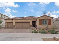 Charming single-story home featuring a three-car garage, desert landscaping and a tile roof at 1269 Olivia Pkwy, Henderson, NV 89011