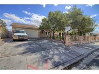 Charming single-story home featuring a large driveway, desert landscaping, and a gated front yard at 1413 Culley St, Las Vegas, NV 89110