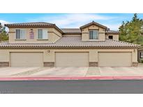 Beautiful condo building featuring attached garages and well-maintained landscaping at 4615 Puglia Ln # 201, North Las Vegas, NV 89084