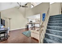 Bright living room with vaulted ceilings, ceiling fan, wood floors and open to the kitchen at 5157 Garden Ln # F, Las Vegas, NV 89119