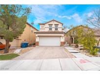 Charming two-story home featuring a paved driveway and a well-maintained front yard at 6177 W Cougar Ave, Las Vegas, NV 89139