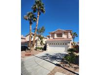 Charming home with a two-car garage, terracotta tiled roof, and palm trees in Las Vegas, Nevada at 7416 Tuckaway Harbor St, Las Vegas, NV 89139