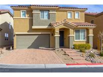 Inviting two-story home features a charming front yard, two car garage and a red tile roof at 806 Neath Ave, Las Vegas, NV 89178