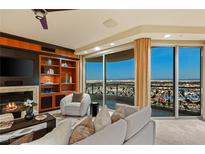 Comfortable living room featuring a fireplace, built-in shelves, and a balcony with expansive city views at 9101 Alta Dr # 1205, Las Vegas, NV 89145