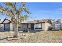 Charming single-story home with desert landscaping and a cozy front porch bench at 100 Grandview Dr, Henderson, NV 89002