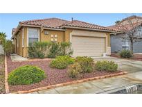 Charming single-story home features a well-manicured front yard and a two-car garage at 10011 W Cherokee Ave, Las Vegas, NV 89147