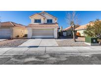 Charming two-story home with a tile roof and well-maintained front yard at 1989 Bookbinder Dr, Las Vegas, NV 89108