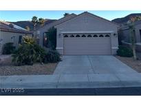 Charming single-story home featuring a two-car garage and desert landscaping at 2147 Indigo Creek Ave, Henderson, NV 89012