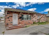 Unique brick home exterior with decorative stones and a secure metal gate at 218 S Bruce St, Las Vegas, NV 89101