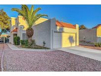 Charming home featuring an attached garage, desert landscaping, and a mature palm tree in the front yard at 3152 Centavo Dr, Las Vegas, NV 89117