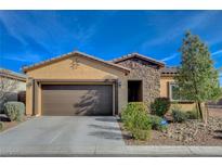 Charming single-story home with a two-car garage and well-maintained landscaping under a bright blue sky at 4459 S Glory Vine Ln, Pahrump, NV 89061
