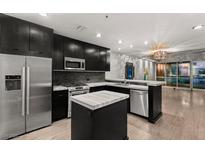 Modern kitchen features stainless appliances, center island, and dark cabinets at 4525 Dean Martin Dr # 511, Las Vegas, NV 89103