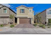 Two-story home featuring a two-car garage, landscaped front yard and charming exterior at 5040 Serene Skies St, Las Vegas, NV 89130