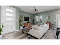 Inviting living room with modern decor, ceiling fan, and wood-look flooring at 600 N Carriage Hill Dr # 1081, Las Vegas, NV 89138