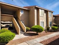 Attractive condo building featuring well-maintained landscaping and stairs to the upper units at 7200 Pirates Cove Rd # 1014, Las Vegas, NV 89145