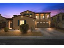 Inviting two-story home with a two-car garage, decorative stone details, and professionally landscaped front yard at 7825 Alameda Creek St, Las Vegas, NV 89113