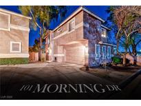 Charming two-story home with a two-car garage and landscaped front yard at dusk at 101 Morning Dr, Henderson, NV 89012
