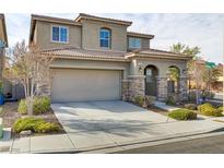 Charming two-story home featuring a tile roof, neutral stucco, stone accents, and a two-car garage at 1053 Hickory Park St, Las Vegas, NV 89138