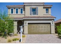 Two-story home with a two-car garage, desert landscaping, and a neutral-toned facade at 1122 Brilliant Meadow Ave, North Las Vegas, NV 89086