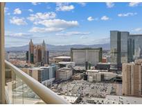 Panoramic city view from a high-rise featuring iconic Las Vegas hotels and the surrounding mountain range at 145 E Harmon Ave # 3005, Las Vegas, NV 89109