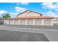 Multiple car garages with individual doors for resident parking with red tile roofs at 2615 W Gary Ave # 1028, Las Vegas, NV 89123