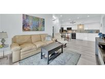 Inviting living room boasts a comfortable leather sofa, contemporary art, and open access to the modern kitchen at 2615 W Gary Ave # 1028, Las Vegas, NV 89123