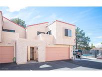 Attractive townhome featuring a private garage and gated entrance near community pool at 3369 Milenko Dr, Las Vegas, NV 89121