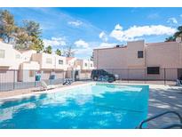 Relaxing community pool area with lounge chairs for residents and guests to enjoy at 3369 Milenko Dr, Las Vegas, NV 89121