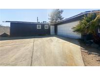 Single-story home featuring an attached garage, desert landscaping, and a spacious driveway at 5305 Alta Dr, Las Vegas, NV 89107