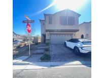 Charming two-story home featuring a two-car garage and desert landscaping at 5773 Fresh Fields Ct, Las Vegas, NV 89118