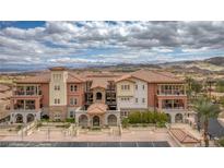 Beautiful condo building features a Spanish-style architecture with a terracotta roof and multiple balconies at 64 Strada Principale # 307, Henderson, NV 89011