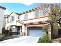 Charming two-story home featuring stone accents, desert landscaping and a spacious driveway at 8348 Mokena Ave, Las Vegas, NV 89178