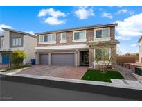 Charming two-story home featuring stone accents, two-car garage, and a well-manicured front lawn at 8415 Iron Heart Ln, Las Vegas, NV 89113
