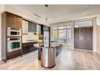 Modern kitchen features stainless steel appliances and a center island with granite countertops at 8925 W Flamingo Rd # 310, Las Vegas, NV 89147